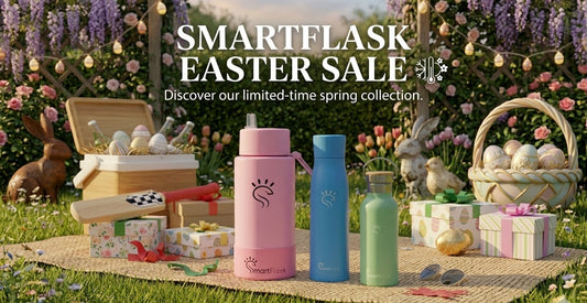 SmartFlask Easter sale banner featuring pink, blue, and mint green insulated water bottles in a spring garden with decorative Easter eggs and wisteria.